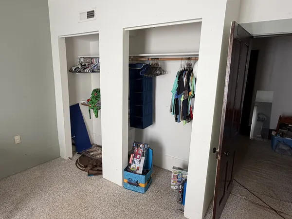 a bedroom with furniture and a window