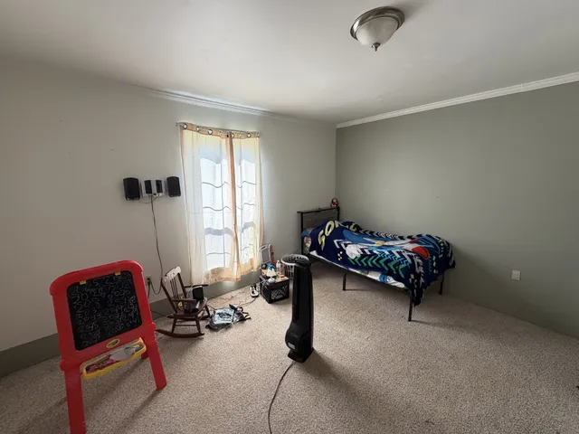 a kitchen with stainless steel appliances granite countertop a dining table and chairs