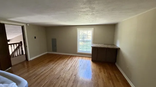 a view of a room with gym equipment and a window