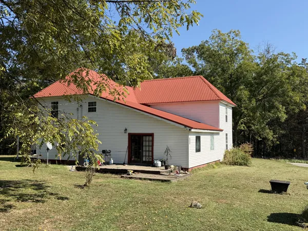 a view of a house with swimming pool and sitting area