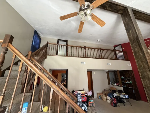 a view of entryway with workspace and stairs