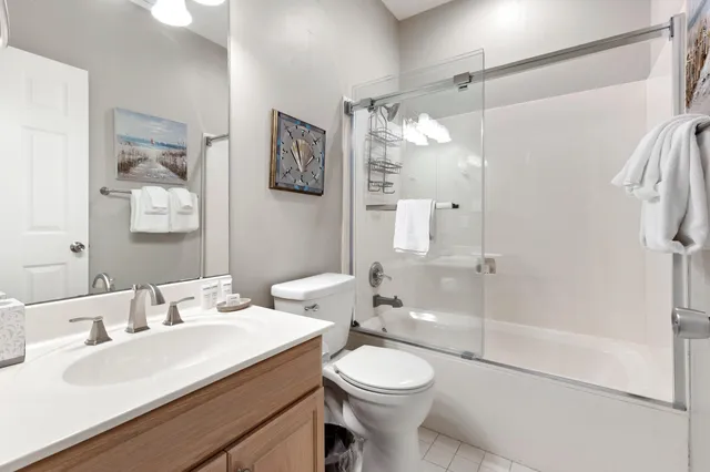 an aerial view of a house with a swimming pool lake and trees all around