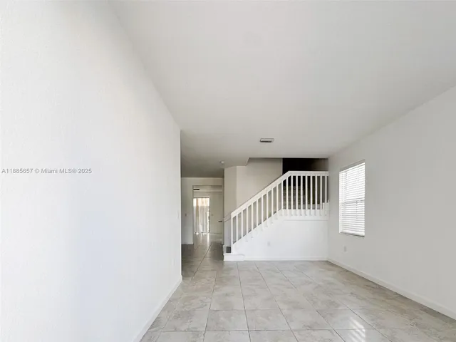 a view of a hallway with stairs