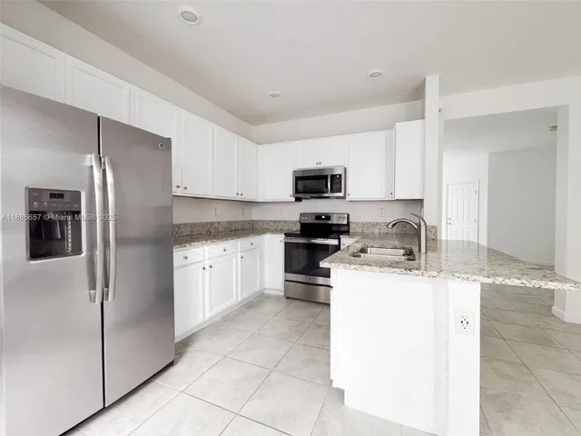 a kitchen with a refrigerator stove and microwave
