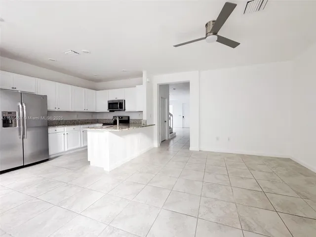 a view of kitchen with stainless steel appliances cabinets