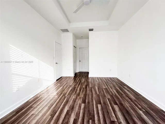 a view of a room with wooden floor