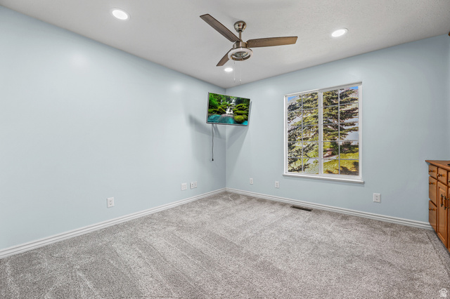 4117 North Wolf Ridge Circle Eden, UT 84310 - Photo 16 of 63 Light blue interior wall paint, recessed ceiling lighting, a ceiling fan, a window, and wood cabinetry