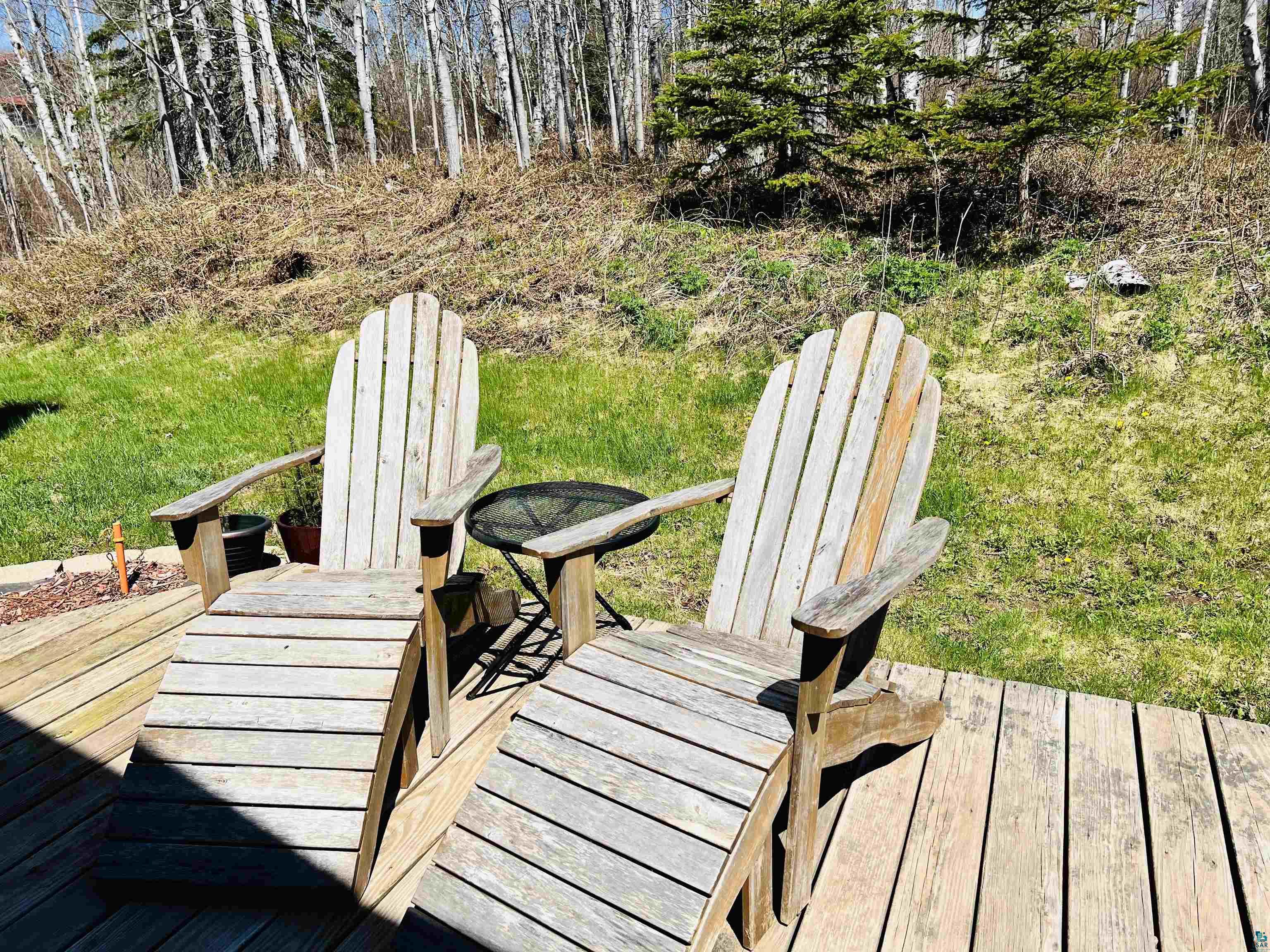 67 Snowshoe Trail Tofte, MN 55615 - Photo 41 of 42 Wood deck with a natural finish, featuring a natural wooded area
