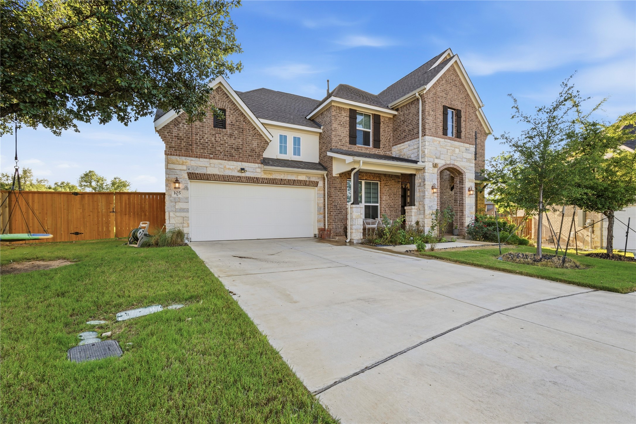 105 Autumn Oak Way Georgetown, TX 78628 - Photo 2 of 40 Two-story facade featuring brick and stone masonry with a covered entryway