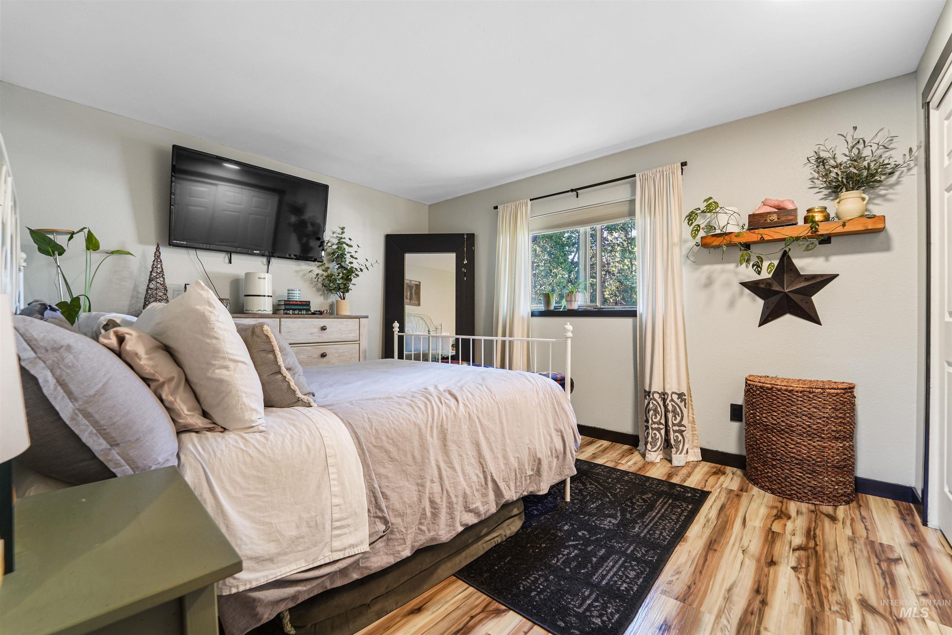 348 North Eagle Road Eagle, ID 83616 - Photo 12 of 31 Bedroom featuring light wood-type flooring and baseboards