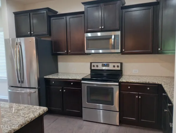 a kitchen with a sink and chandelier