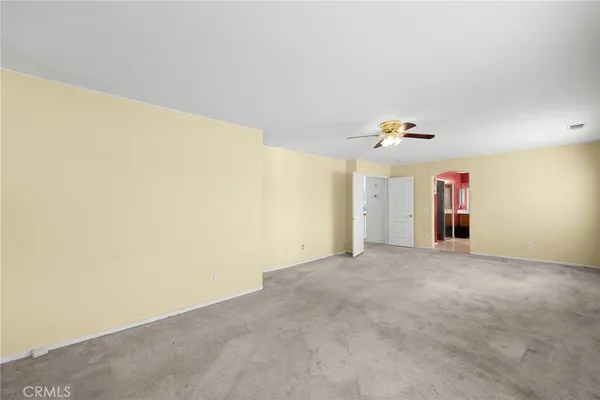 a view of a livingroom with a ceiling fan and window