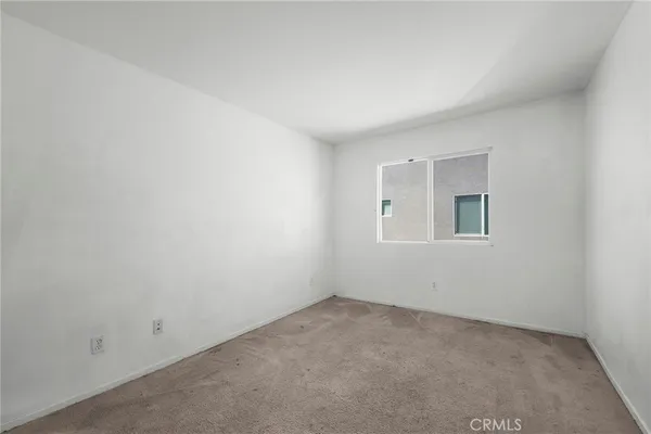 a bedroom with a bed and a night stand