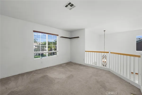 a living room with furniture a rug and a window