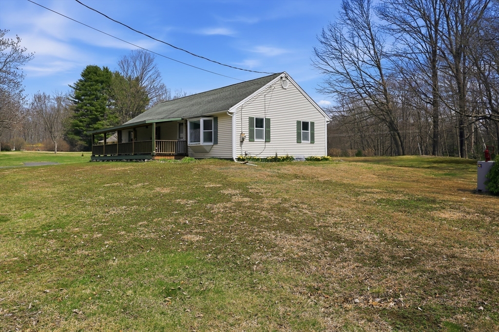 240 Upper Road Deerfield, MA 01342 - Photo 39 of 42 a view of a yard in front of a house with a large tree