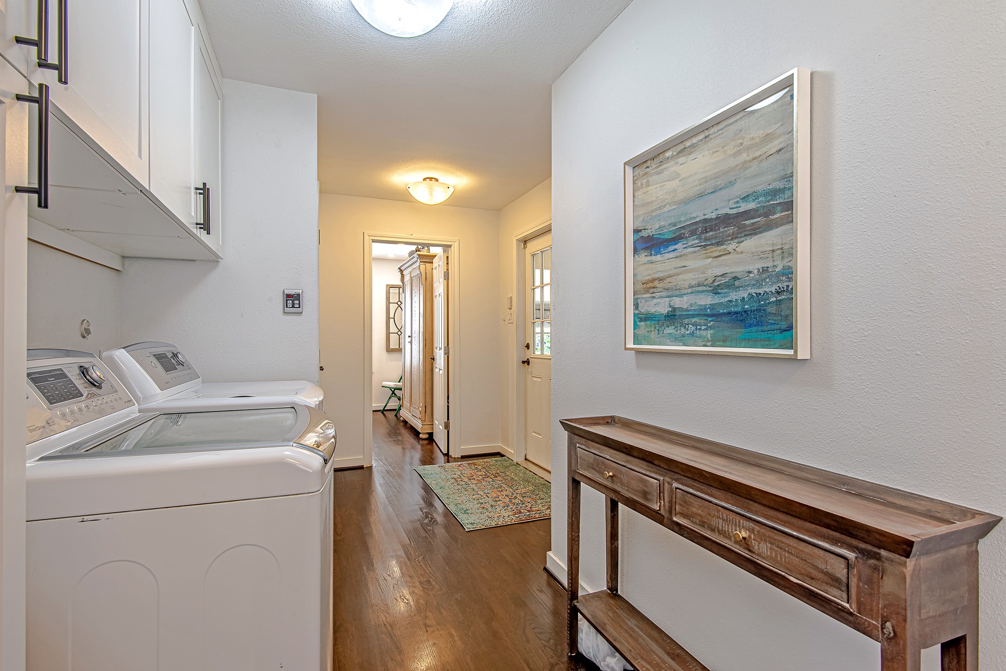 520 West 30th Street Houston, TX 77018 - Photo 14 of 28 This hallway offers convenient access to both the laundry area and the attached garage, enhancing the home's functionality.