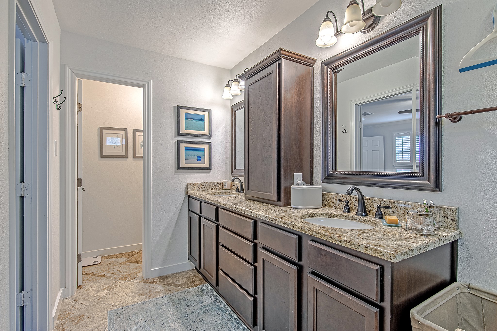 520 West 30th Street Houston, TX 77018 - Photo 19 of 28 This view of the ensuite bathroom highlights the double vanity with granite countertops and ample storage. The water closet is tucked away for added privacy, while the spacious layout ensures a comfortable and functional space.