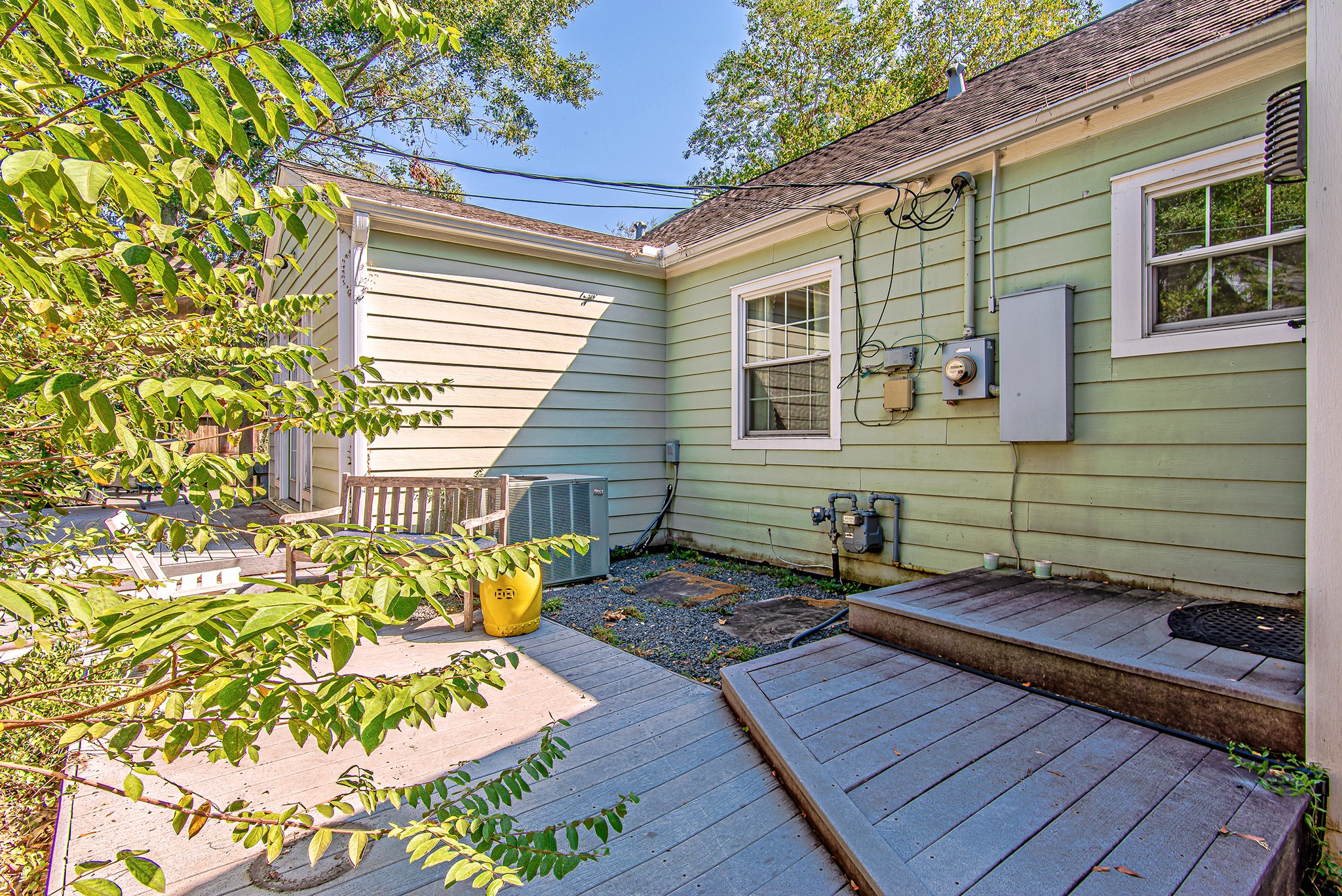 520 West 30th Street Houston, TX 77018 - Photo 24 of 28 This backyard exit, conveniently located behind the kitchen and near the primary bedroom, offers easy outdoor access. The small deck and surrounding greenery provide a functional outdoor space for relaxation or future enhancements.