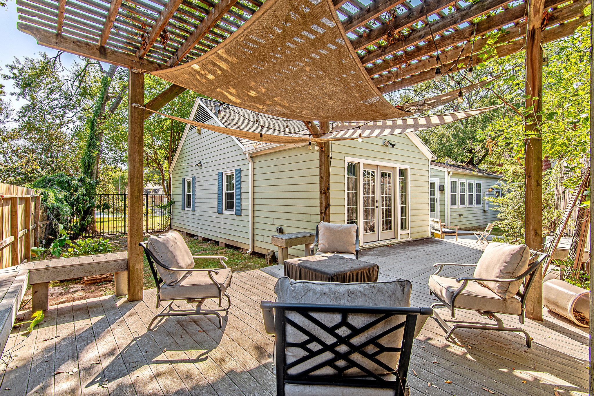 520 West 30th Street Houston, TX 77018 - Photo 26 of 28 This spacious backyard deck features a shaded pergola, perfect for outdoor lounging. Adjacent to the deck is a well-maintained green space, providing plenty of room for gardening or recreational activities.