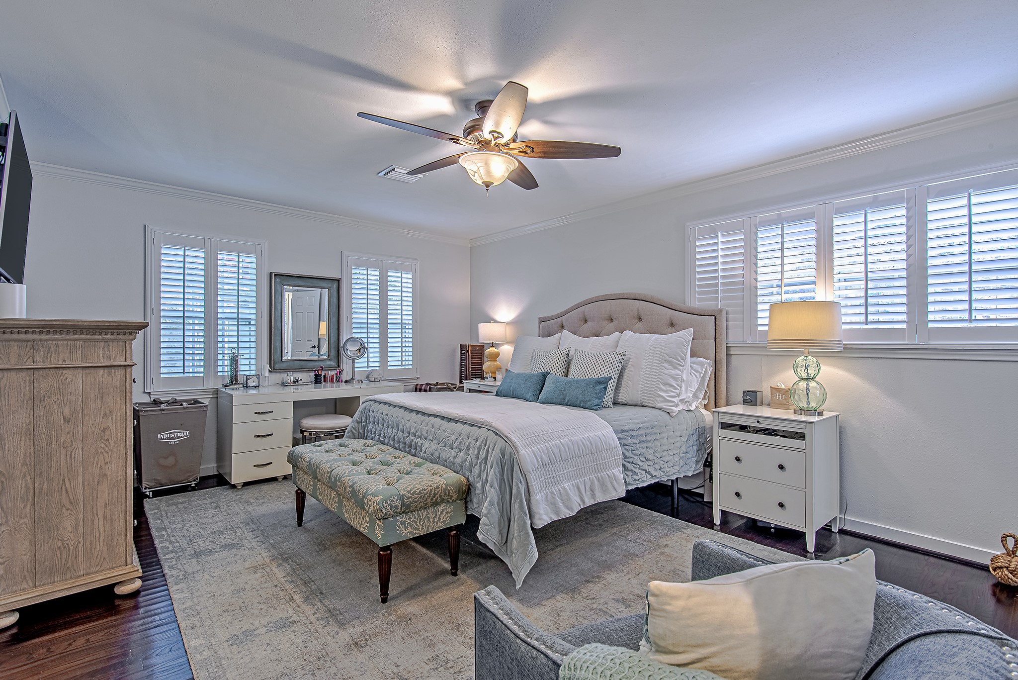 520 West 30th Street Houston, TX 77018 - Photo 4 of 28 This elegant primary bedroom offers a serene and spacious retreat. Natural light streams through multiple windows with plantation shutters, creating a bright yet relaxing space, ideal for unwinding in style.