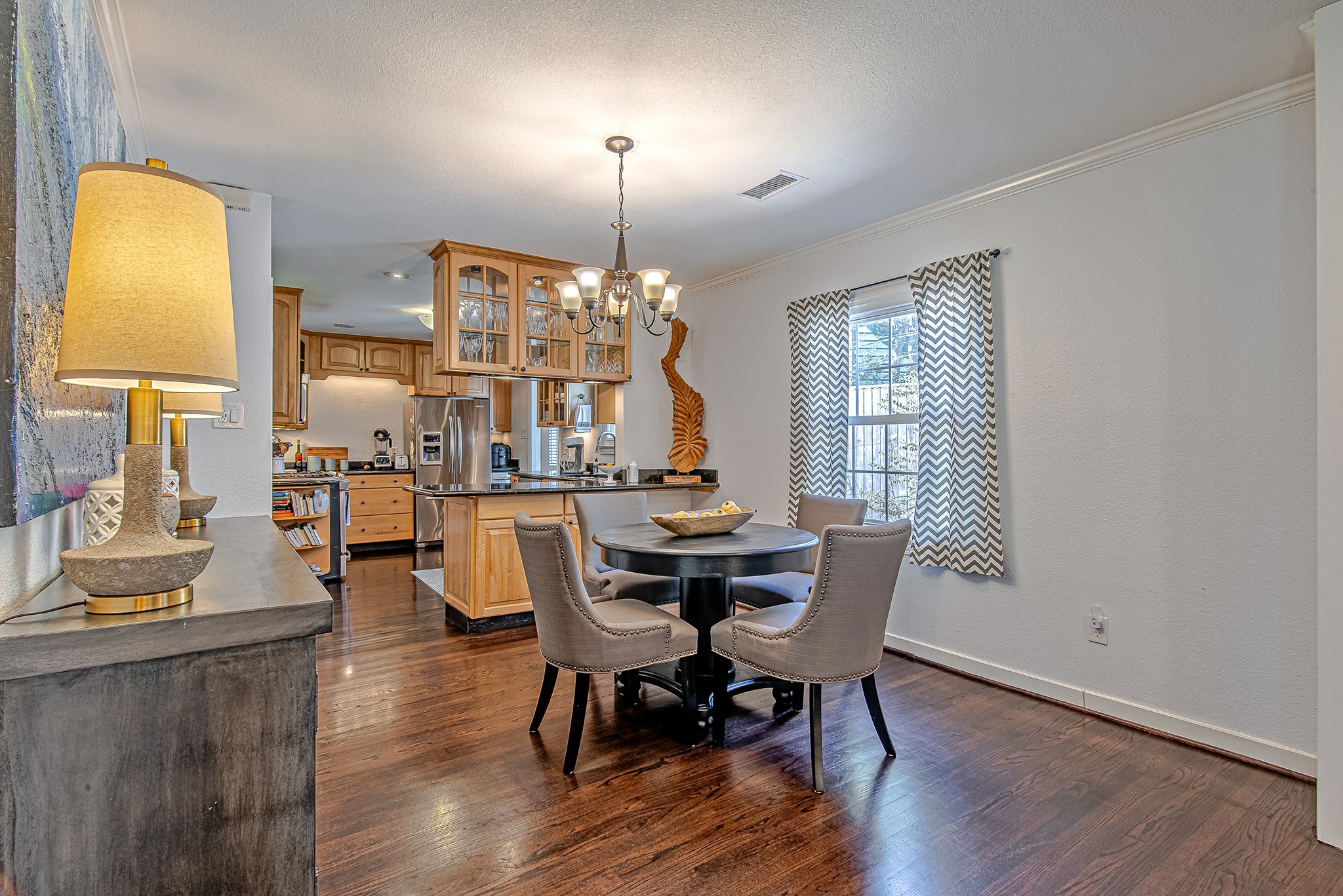 520 West 30th Street Houston, TX 77018 - Photo 8 of 28 This intimate dining area, located between the living room and kitchen, is perfect for family meals or entertaining guests. The open concept, natural light, and easy access to the kitchen create a comfortable and inviting atmosphere.