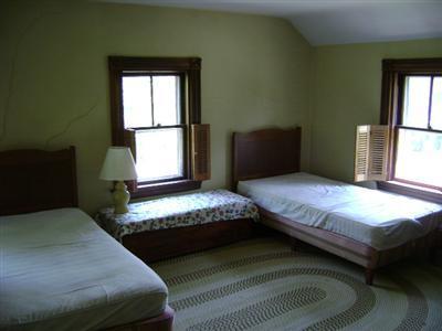 68 Nickerson Road Cotuit, MA 02635 - Photo 5 of 12 a bedroom with a bed and window