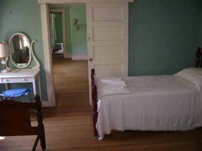 68 Nickerson Road Cotuit, MA 02635 - Photo 7 of 12 a bedroom with a bed and a fireplace