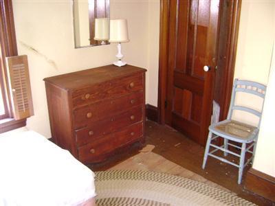 68 Nickerson Road Cotuit, MA 02635 - Photo 8 of 12 a bedroom with a bed and a mirror