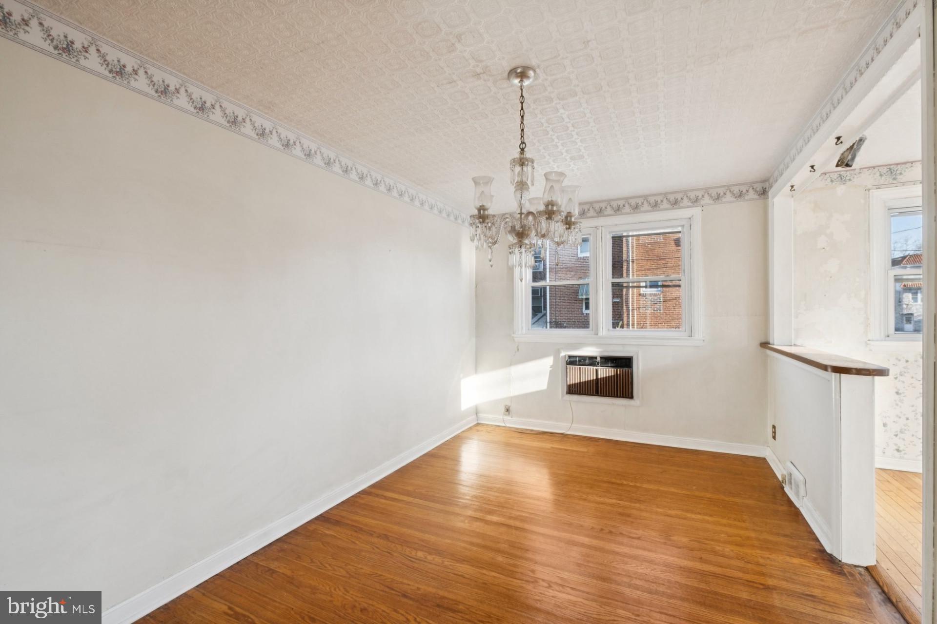 3051 Gilham Street Philadelphia, PA 19149 - Photo 6 of 10 a view of a room with wooden floor staircase and a kitchen