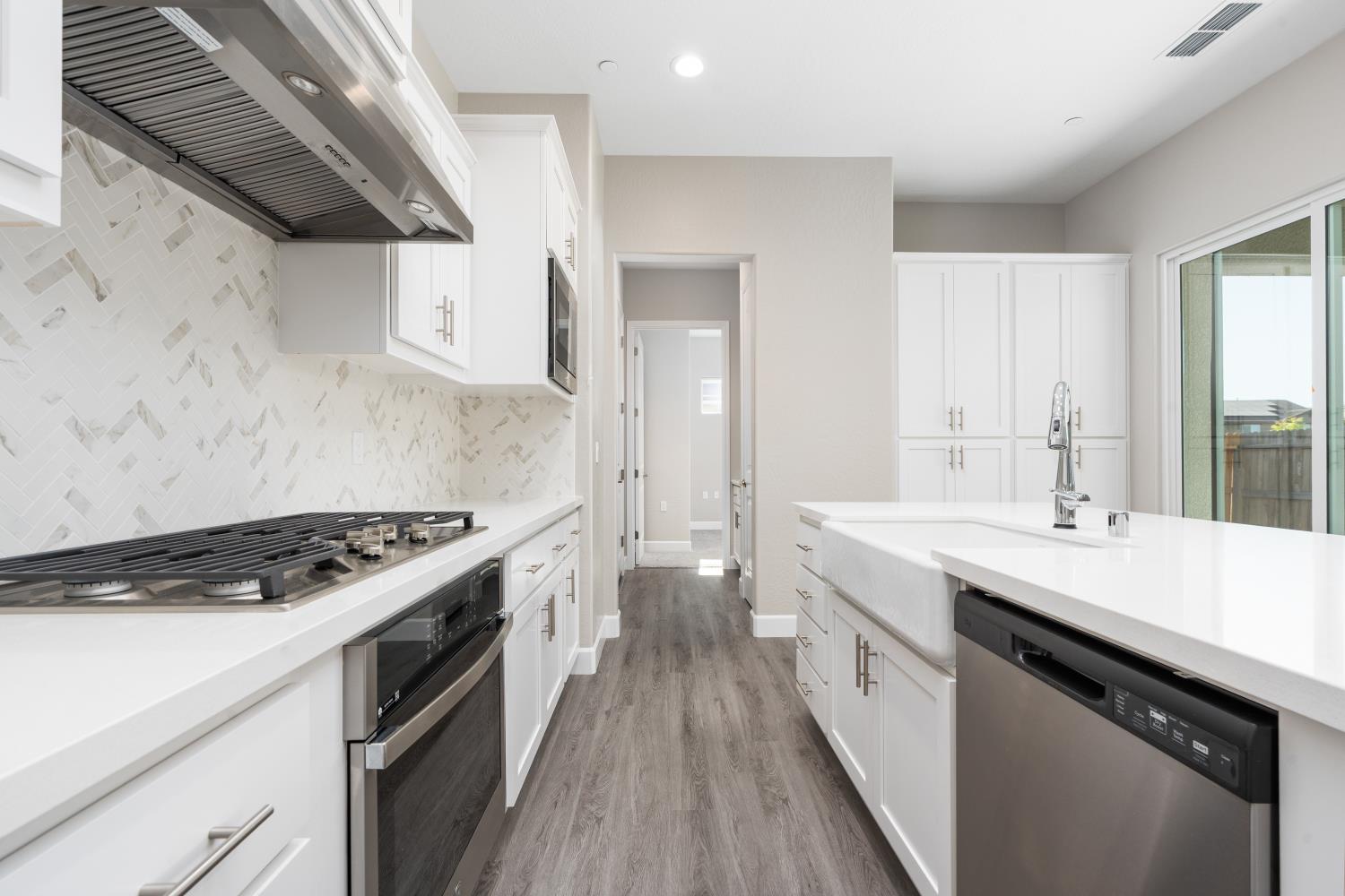 272 Peters Road Madera, CA 93636 - Photo 11 of 25 a kitchen with granite countertop a sink stove and cabinets