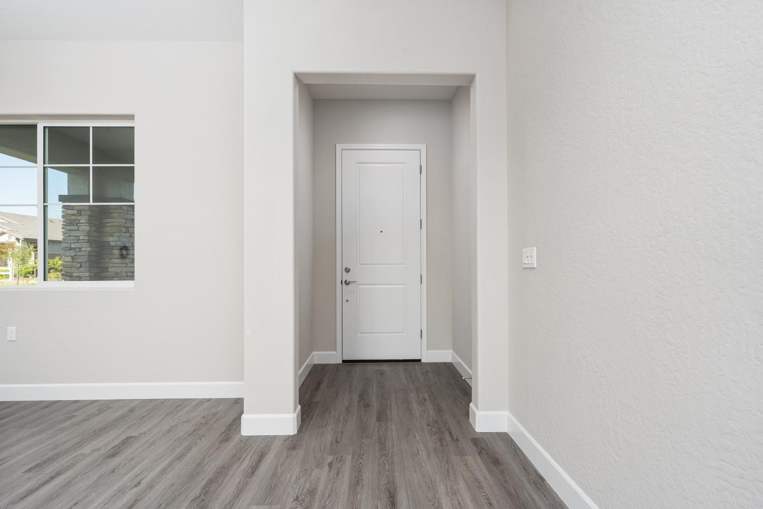 272 Peters Road Madera, CA 93636 - Photo 2 of 25 a view of a hallway with wooden floor and a window