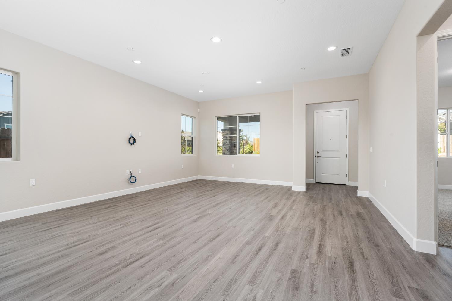 272 Peters Road Madera, CA 93636 - Photo 3 of 25 an empty room with wooden floor and windows