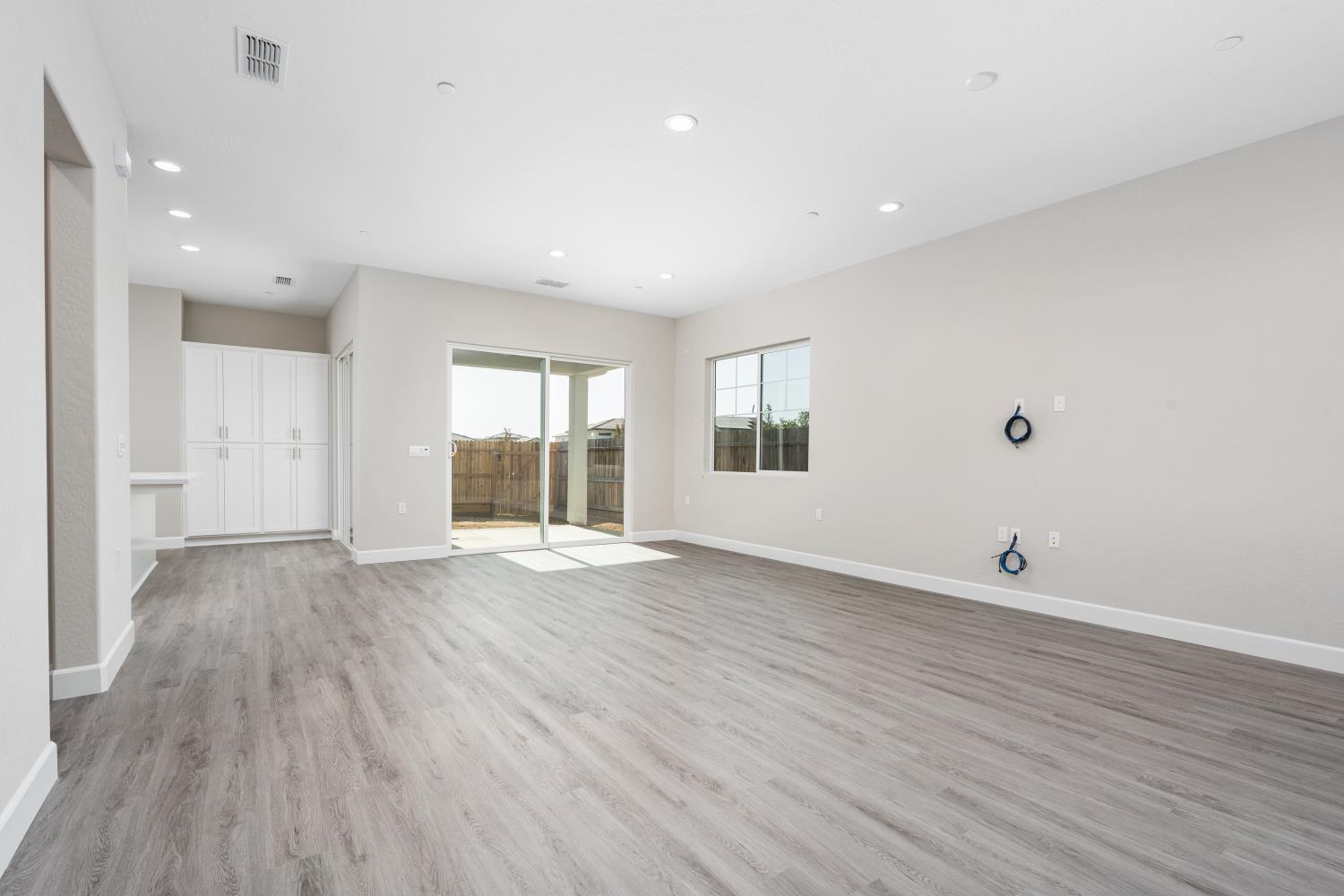 272 Peters Road Madera, CA 93636 - Photo 4 of 25 a view of an empty room with wooden floor and a window