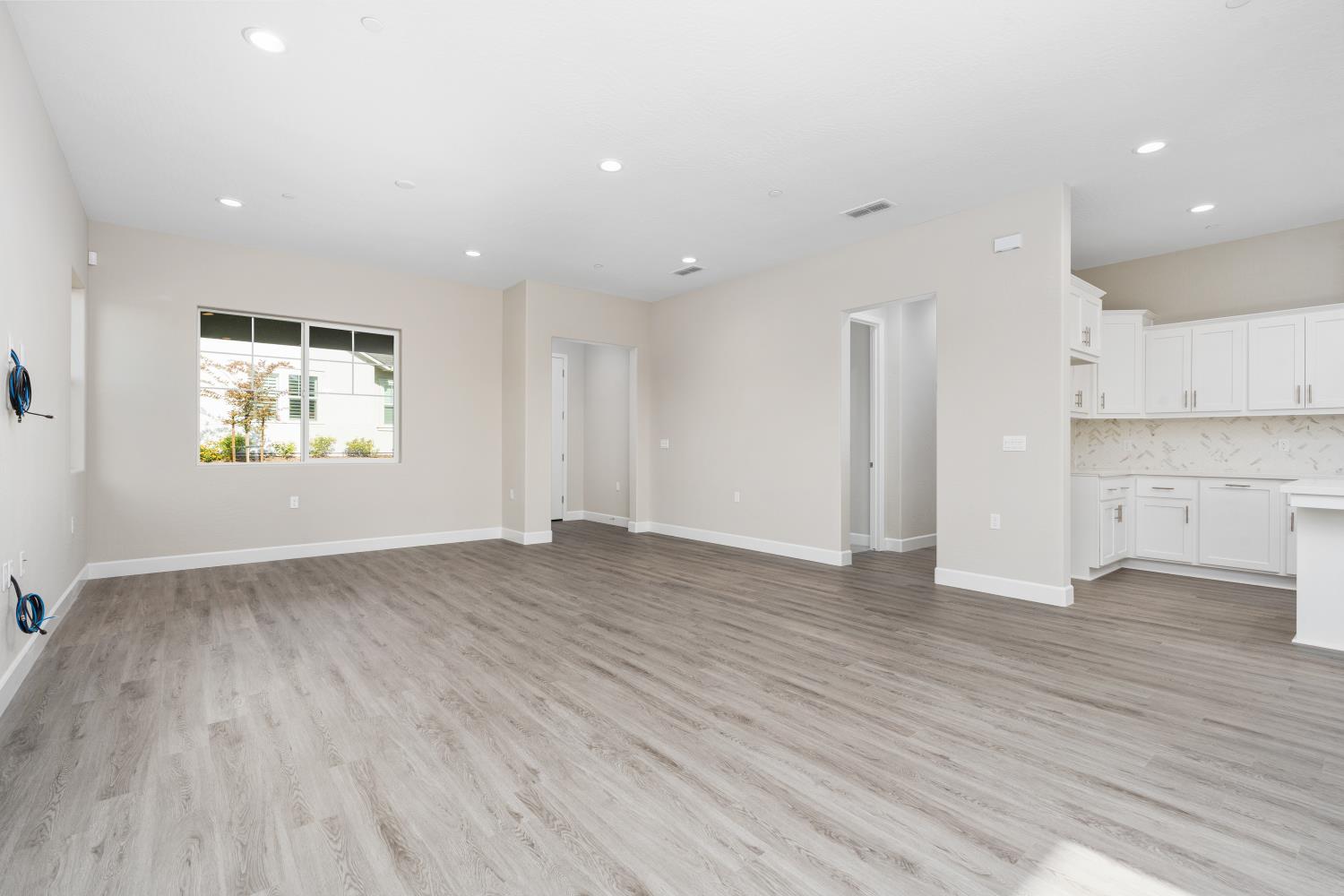 272 Peters Road Madera, CA 93636 - Photo 6 of 25 an empty room with wooden floor and windows