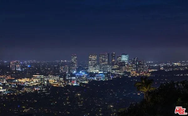 a view of a house with swimming pool and sitting area