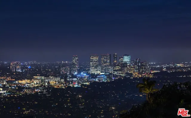 a view of a house with swimming pool and sitting area
