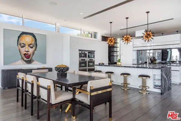 a kitchen with lots of counter and windows