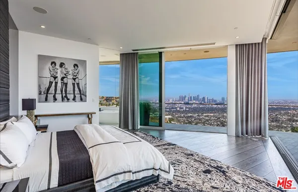 a living room with patio furniture and a floor to ceiling window