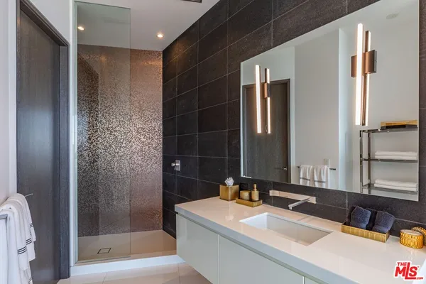 a bedroom with a large bed and a lamp next to a window