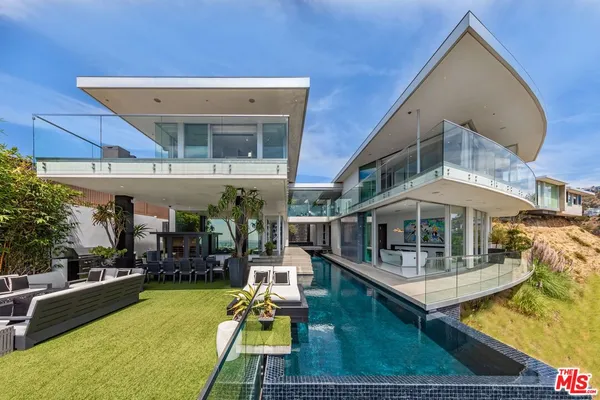 a view of a patio with a table and chairs under an umbrella