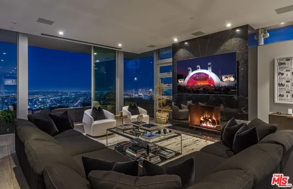a living room with furniture and floor to ceiling window