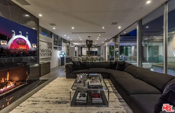 a kitchen with kitchen island granite countertop a sink a counter top space appliances and cabinets
