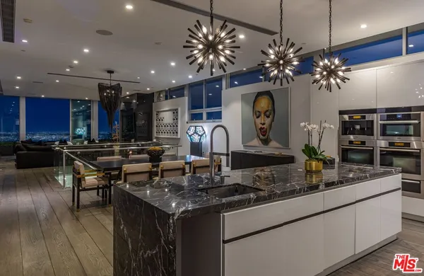 a room with lot of large windows and furniture