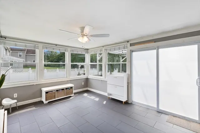 a large white room with a large window and chandelier