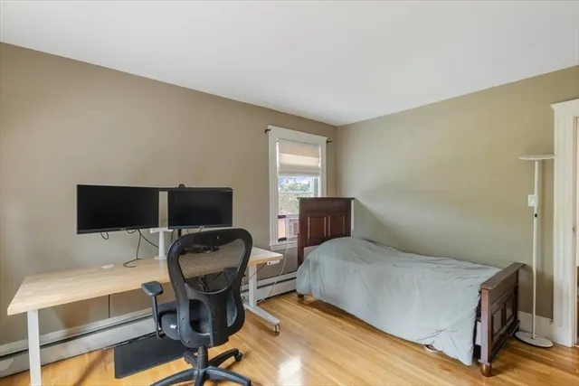 a bedroom with a bed and a large window