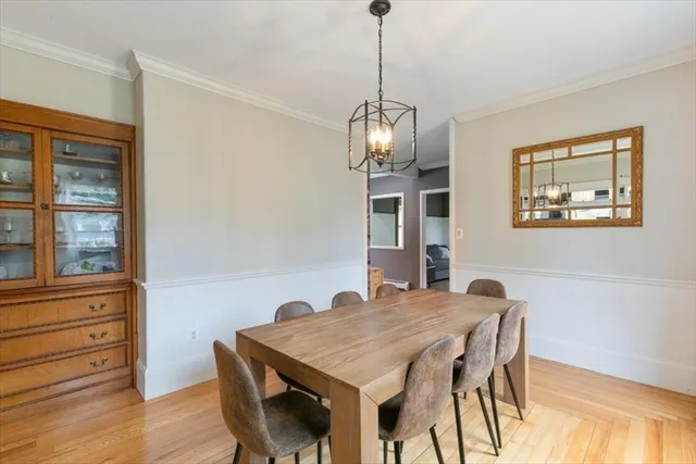 a view of a dining room with furniture wooden floor and chandelier