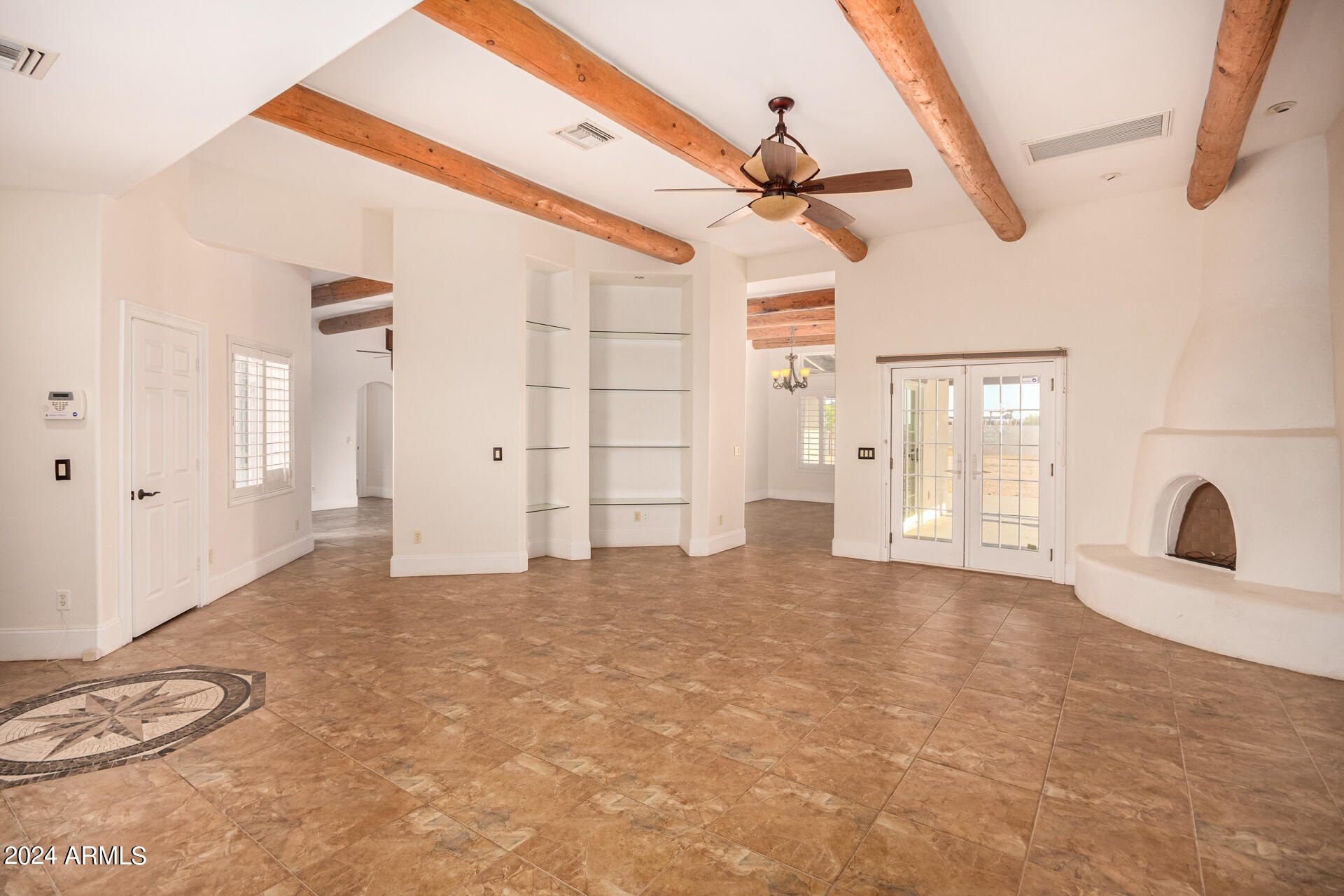 10589 West Harmon Road Eloy, AZ 85131 - Photo 17 of 82 a view of a livingroom with wooden floor and a ceiling fan
