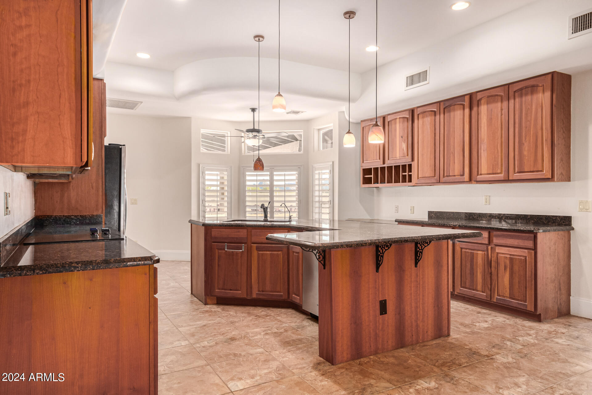 10589 West Harmon Road Eloy, AZ 85131 - Photo 25 of 82 a kitchen with stainless steel appliances granite countertop wooden cabinets a stove a sink dishwasher and a refrigerator
