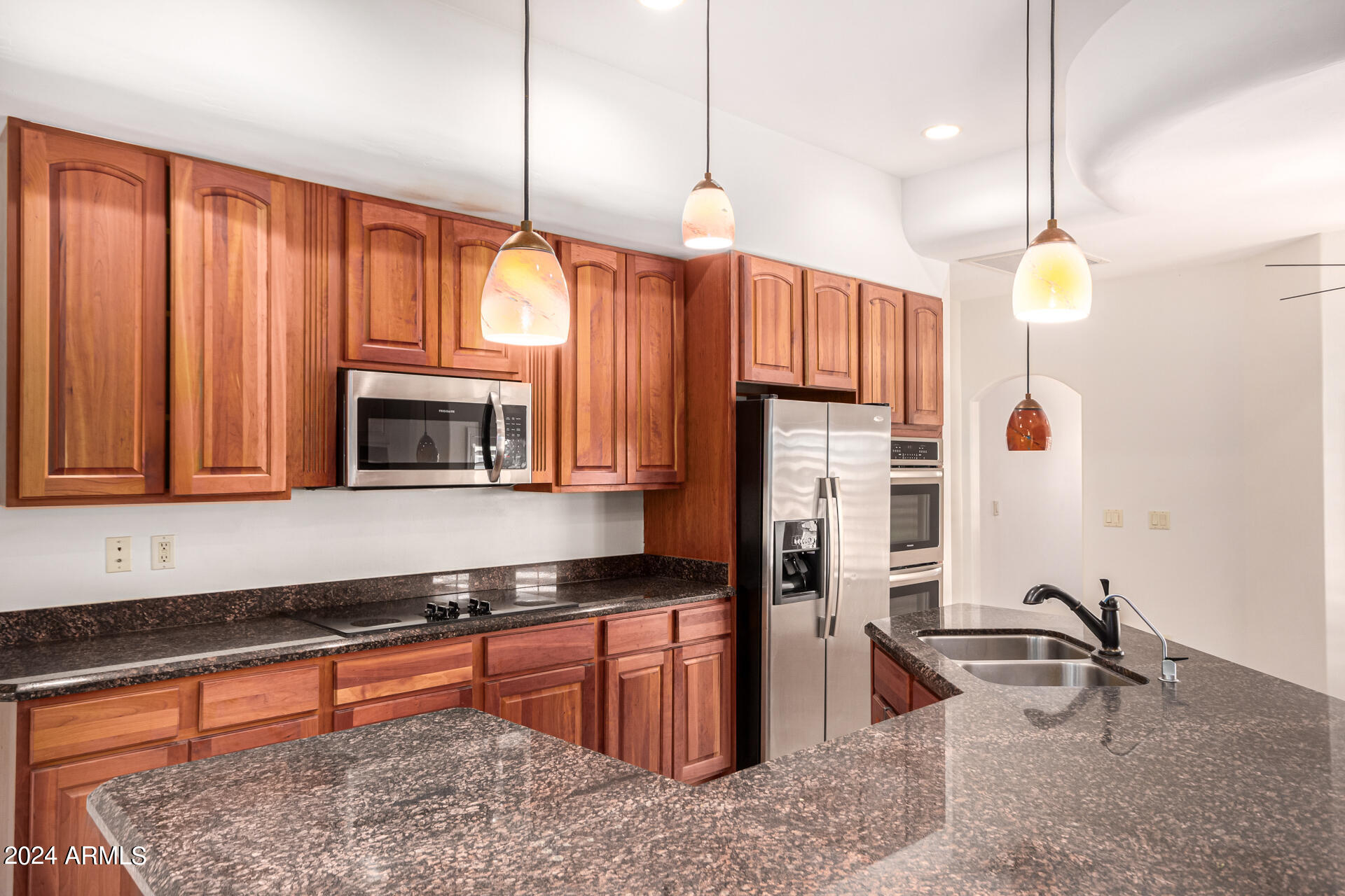 10589 West Harmon Road Eloy, AZ 85131 - Photo 26 of 82 a kitchen with stainless steel appliances granite countertop a stove a sink and a microwave