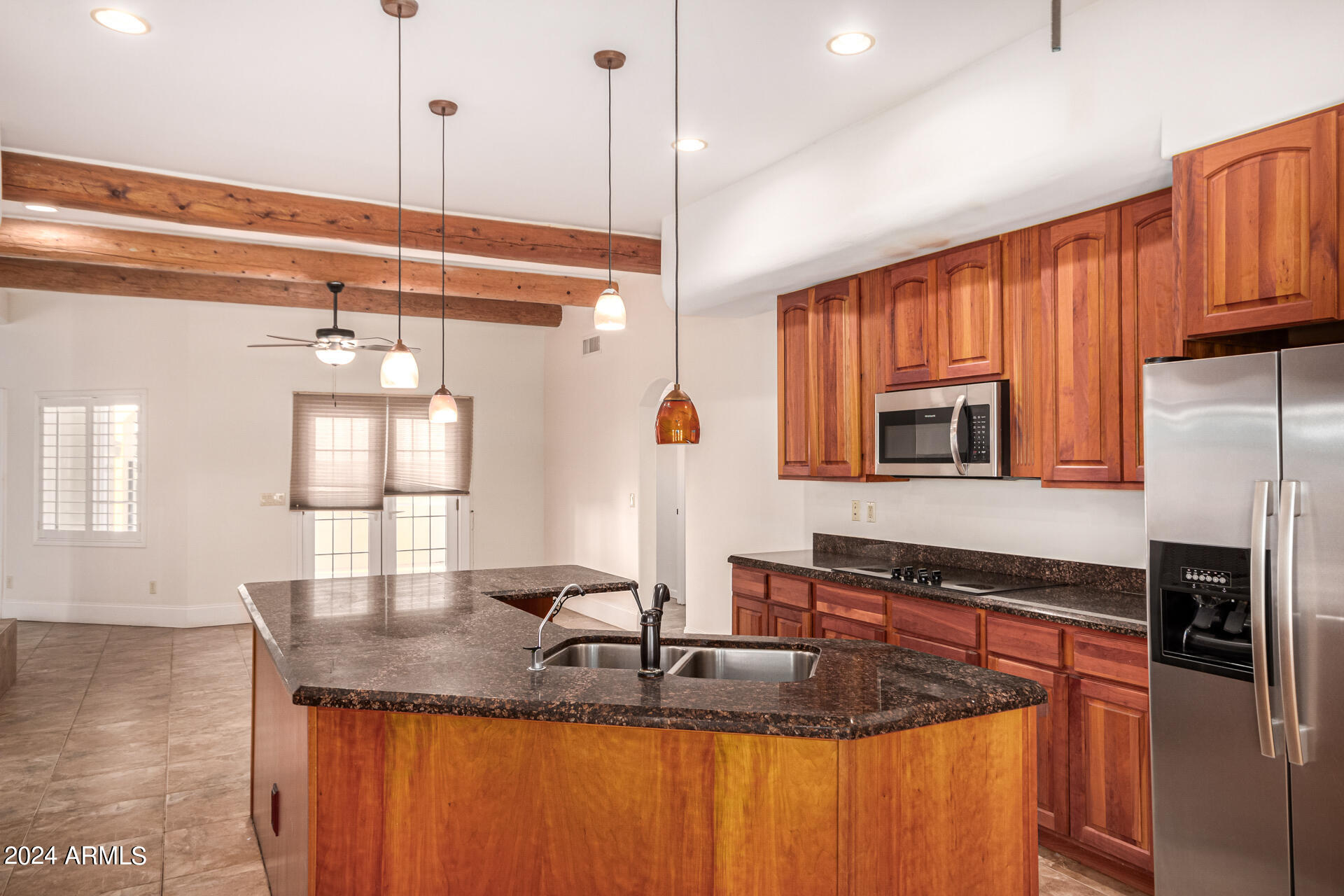 10589 West Harmon Road Eloy, AZ 85131 - Photo 29 of 82 a kitchen with stainless steel appliances granite countertop a sink a microwave and wooden cabinets